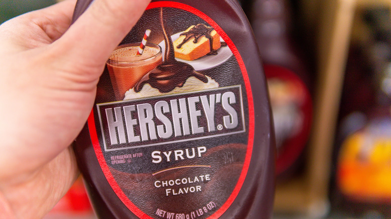 Hershey's chocolate syrup in hand