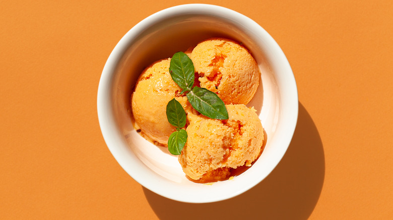 Peach ice cream in bowl