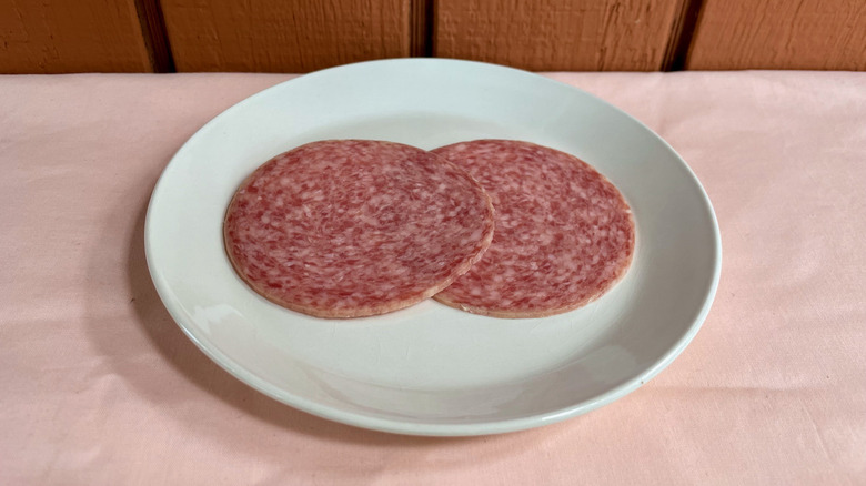 Hard salami slices on plate