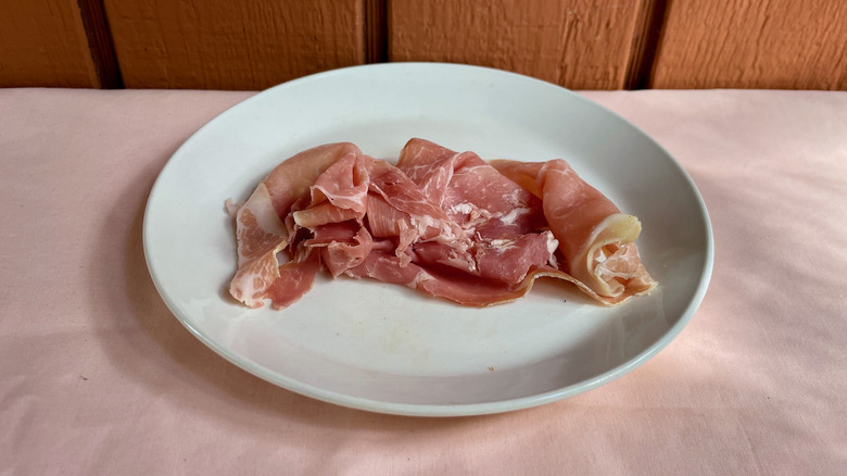 Prosciutto slices on plate