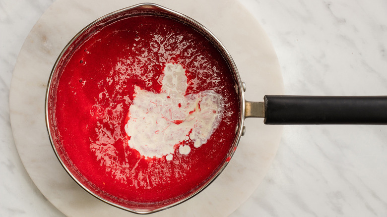 raspberry puree heavy cream in a saucepan