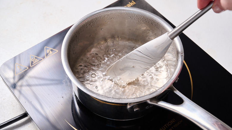 stirring water in saucepan