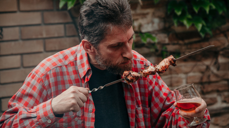 man with smoked meat and beer