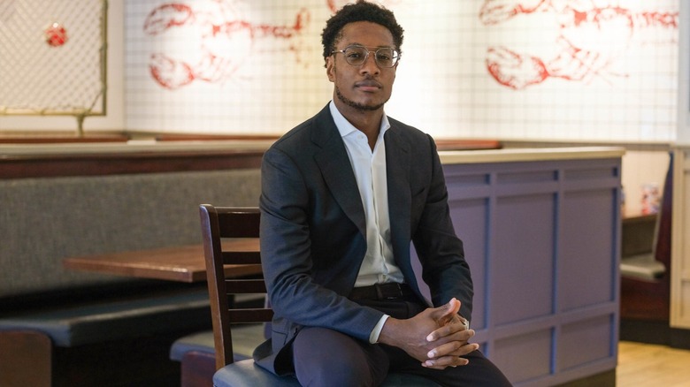 damola adamolekun sitting on chair