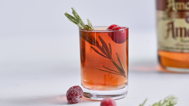 red snapper shot with rosemary and cranberry garnish