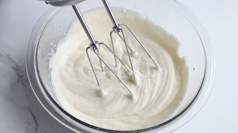 beating icing in bowl