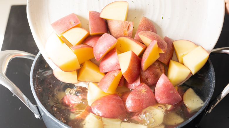 chopped potatoes in pot 