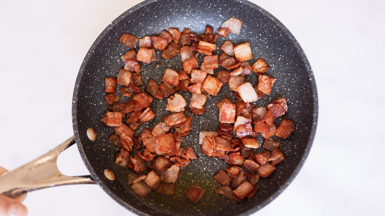 chopped bacon in frying pan