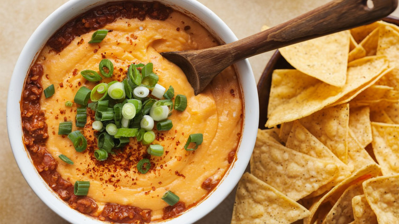 queso vegetable dip in bowl with chips