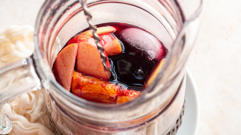 stirring a pitcher of sangria