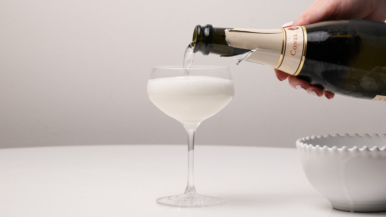 pouring Prosecco into sgroppino cocktail