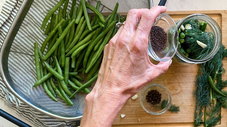 adding ingredients to jars