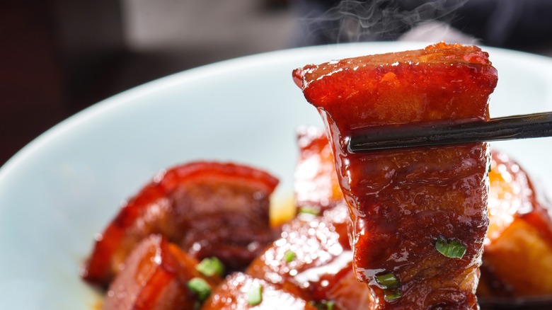 chopsticks picking up dongpo pork