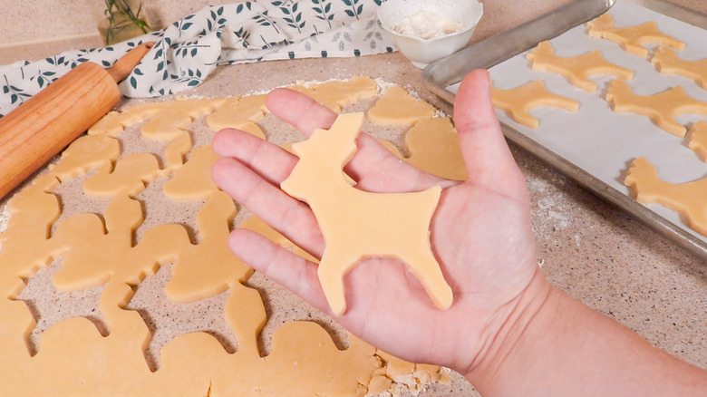 cutting reindeer sugar cookies
