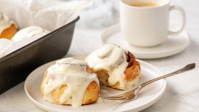 Cinnamon rolls with cream cheese frosting on plate