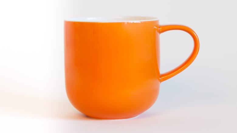 Orange mug on white background