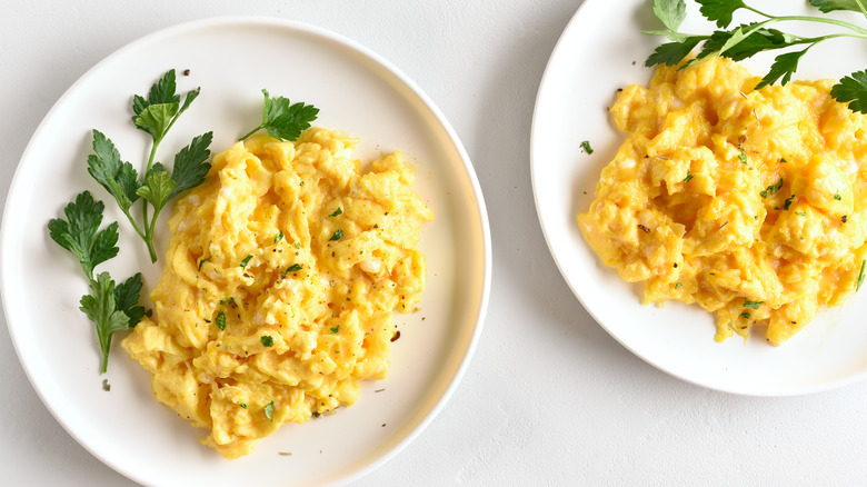 Two plates of scrambled eggs