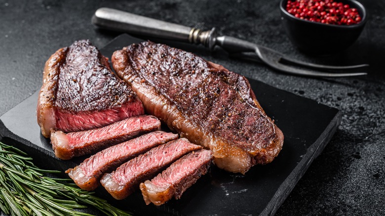 Sliced steak on stone board