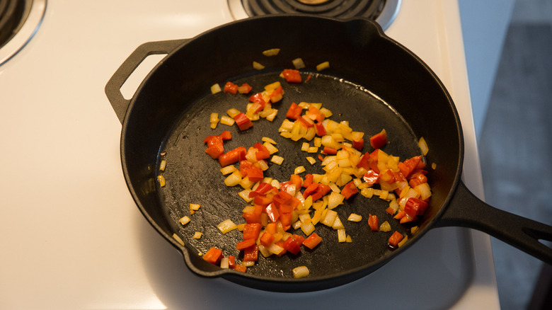 vegetables sauteing in iron pan 