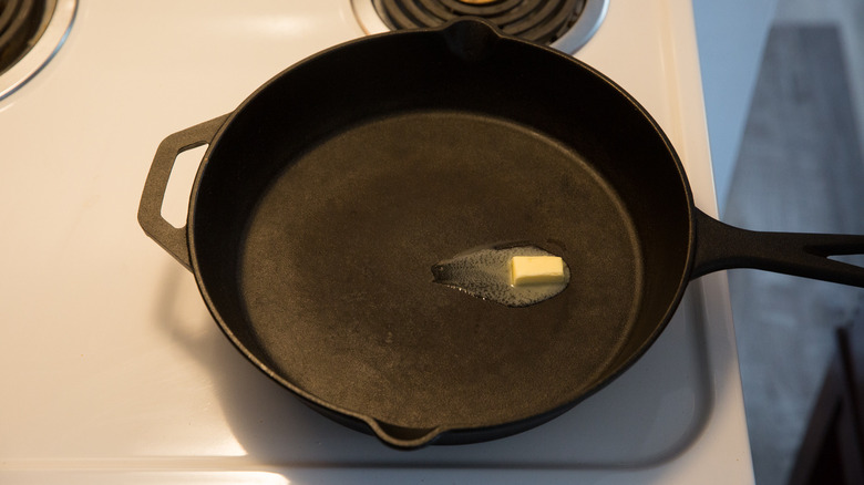 butter melting in iron pan 