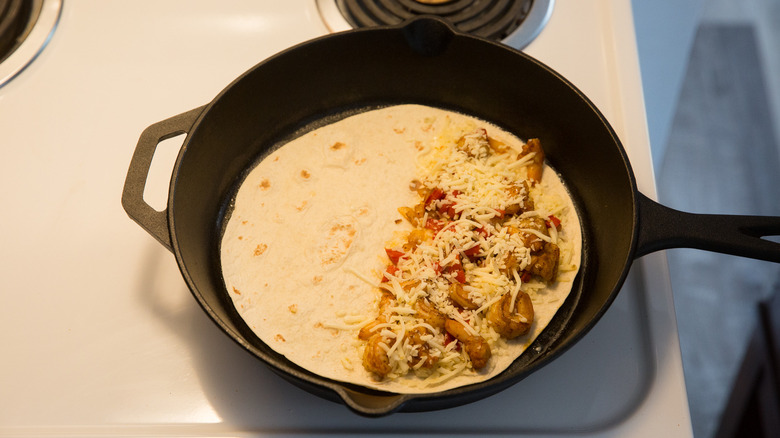 tortilla and fillings in skillet 
