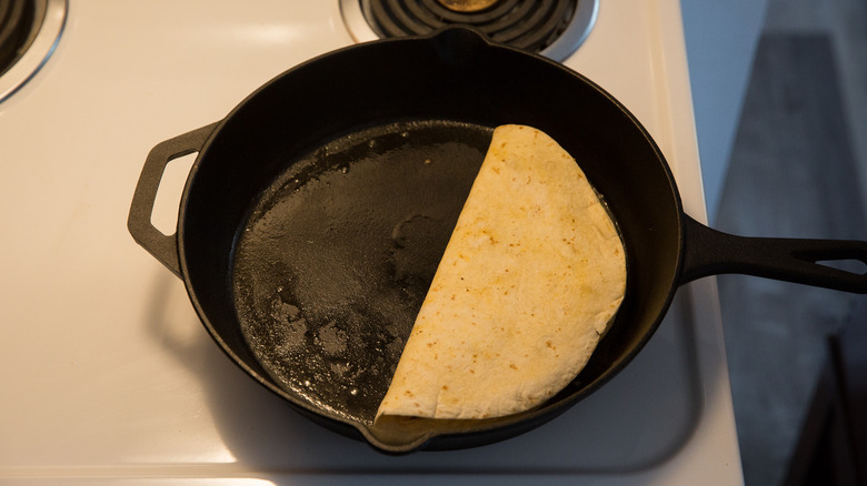 folded tortilla cooking in pan 