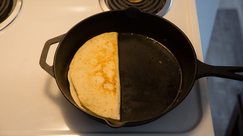 folded tortilla cooking in pan 