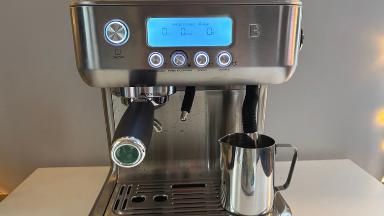 Casabrews espresso machine fitted with portafilter and milk pitcher