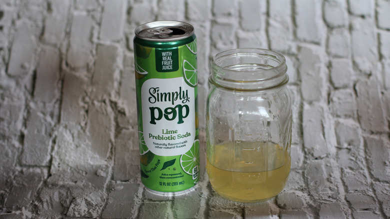 Lime Simply Pop with glass on gray background