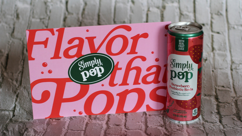 Simply Pop can with mailer on brick background