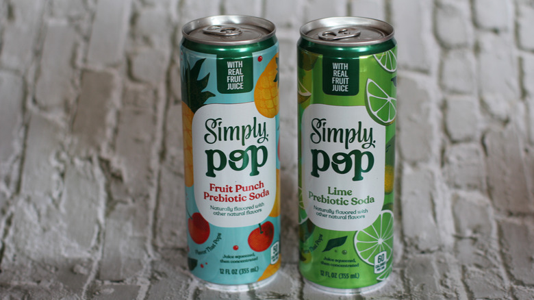 Simply Pop soda cans on brick background