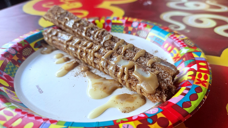 Close up of the Disney's Vietnamese coffee churro, with icing and coffee sugar.