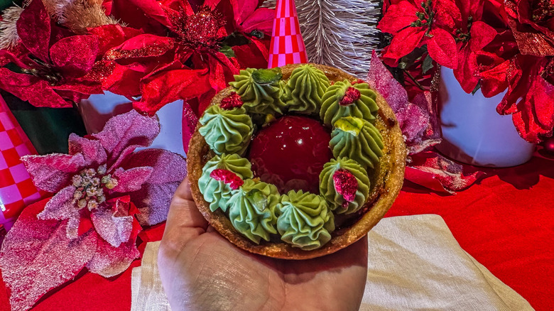 Starbucks Reserve Pistachio Raspberry Tart held above table