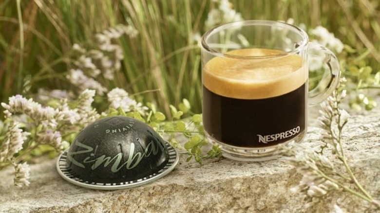 Tamuka mu Zimbabwe Nespresso Vertuo pod next to coffee mug