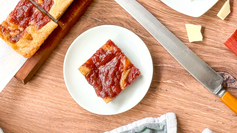 Rhubarb and white chocolate blondies on table with knife