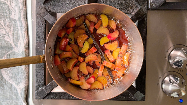 Rhubarb compote simmering in saucepan on stovetop