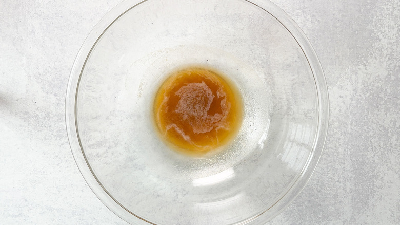 Brown butter cooling in glass bowl on countertop