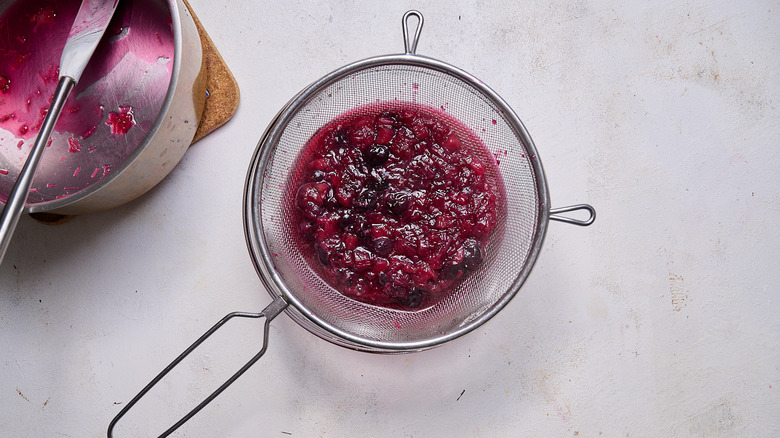 straining syrup into bowl