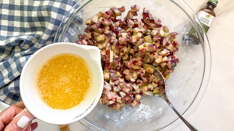 rhubarb in glass bowl with cup of sugar