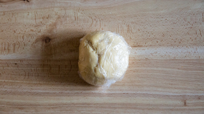 wrapped dough ball on table