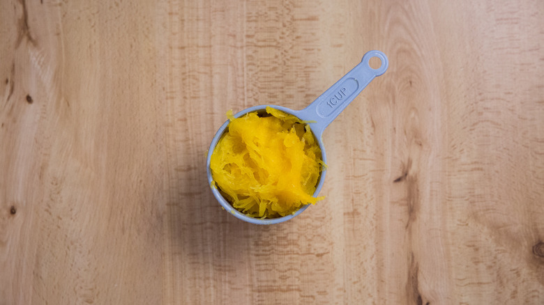 pumpkin puree in measuring cup