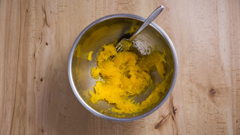 mashed pumpkin in metal bowl