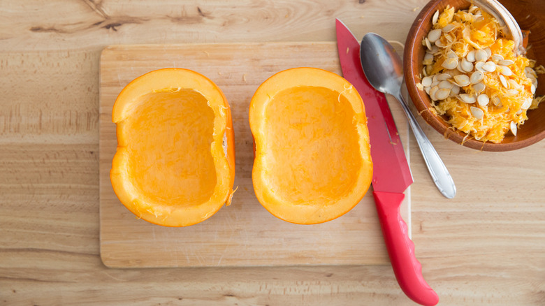 pumpkin halves on cutting board