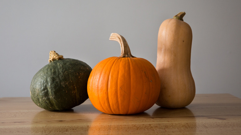 assorted squash on wooden table