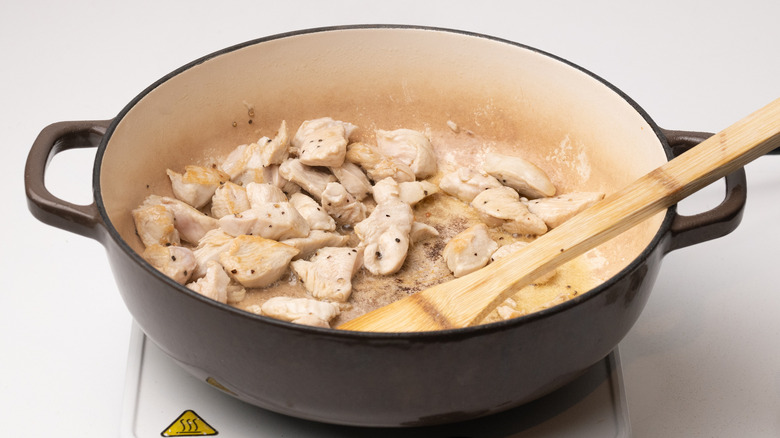 chicken frying in pan