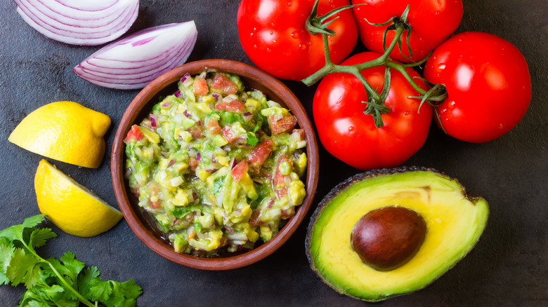 Guacamole ingredients on a black background