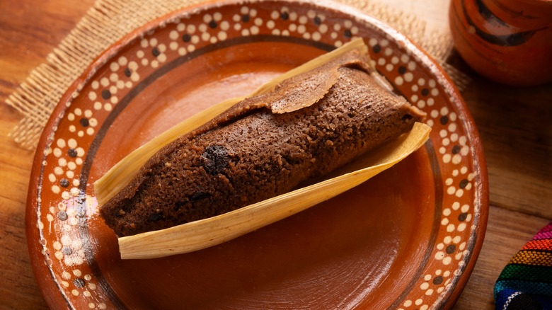 chocolate tamal on clay plate