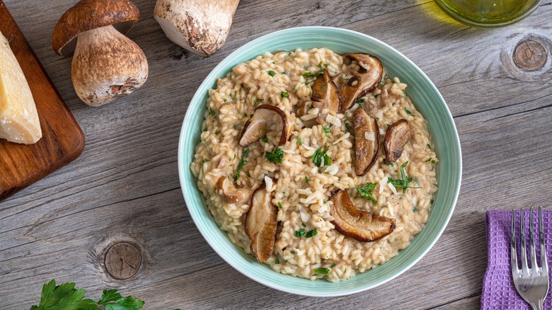 mushroom risotto on wooden table