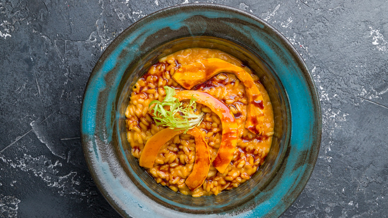 risotto with pumpkin on dark table top