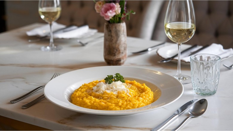 plate of risotto milanese at restaurant table